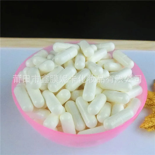 Enzyme cleansing powder capsules in a pink bowl for facial cleansing, featuring amino acids for deep cleaning and oil control.