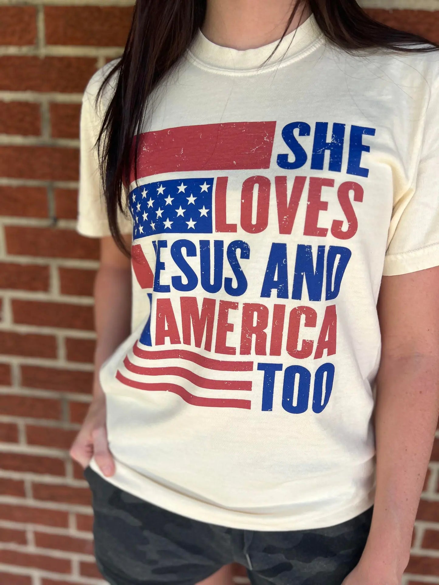 She Loves Jesus and America Too TeeAmerica and Jesus, that's all we need! This comfy tee is the perfect top for any patriotic holiday!
Model is wearing a size Small, her true size.Loves Jesus