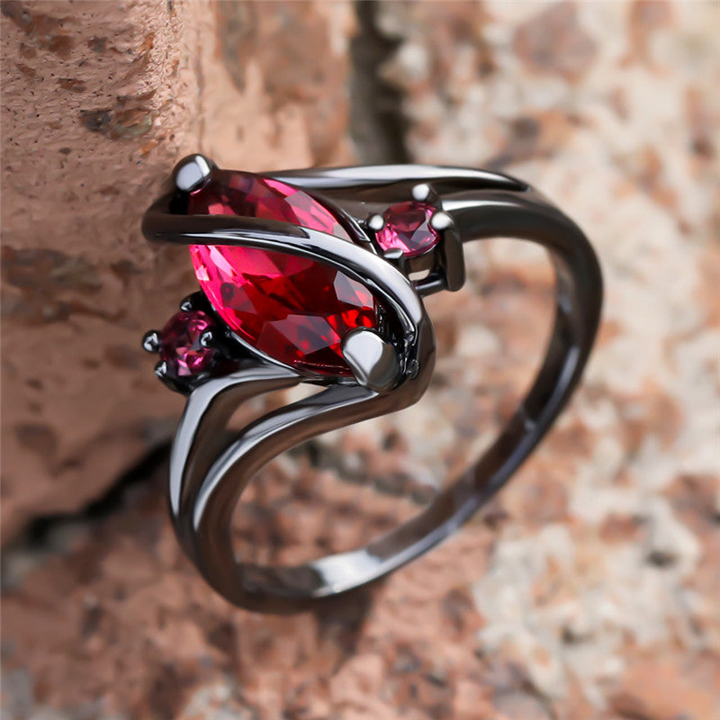 Crystal RingIntroducing the Crystal Ring â a stunning piece of jewelry that is sure to turn heads. This beautiful ring features a large red leaf crystal in the center, surrounCrystal Ring