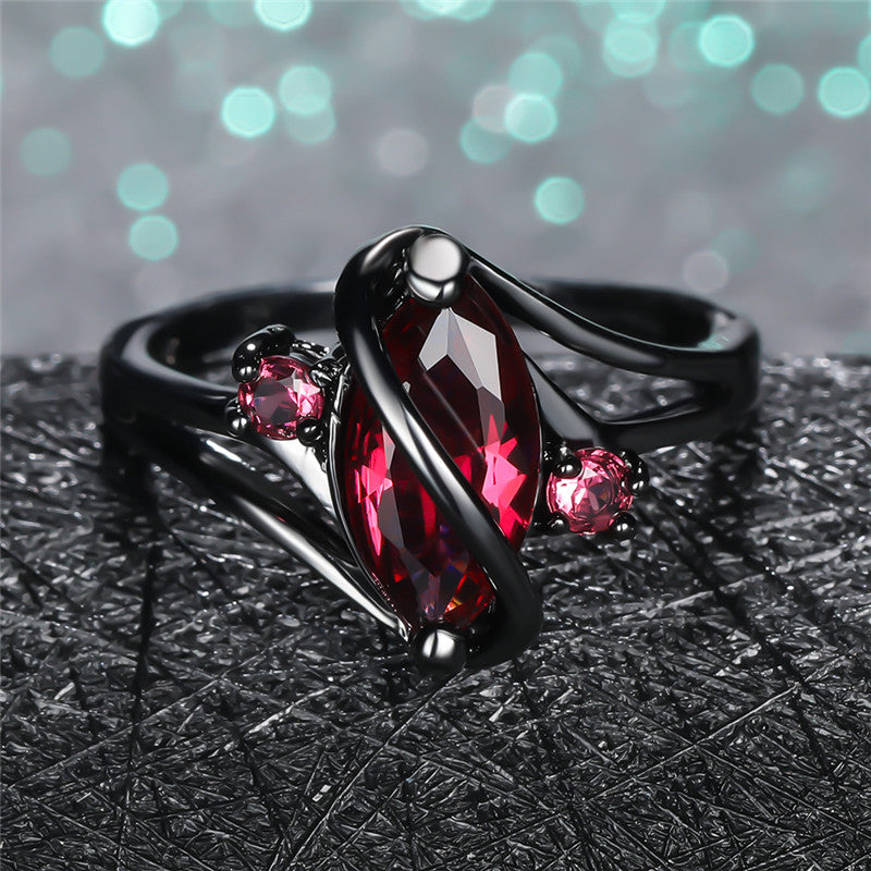 Crystal RingIntroducing the Crystal Ring â a stunning piece of jewelry that is sure to turn heads. This beautiful ring features a large red leaf crystal in the center, surrounCrystal Ring