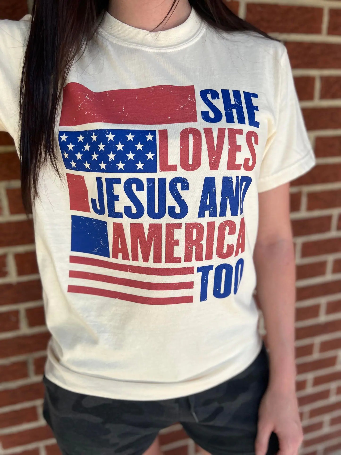 She Loves Jesus and America Too TeeAmerica and Jesus, that's all we need! This comfy tee is the perfect top for any patriotic holiday!
Model is wearing a size Small, her true size.Loves Jesus