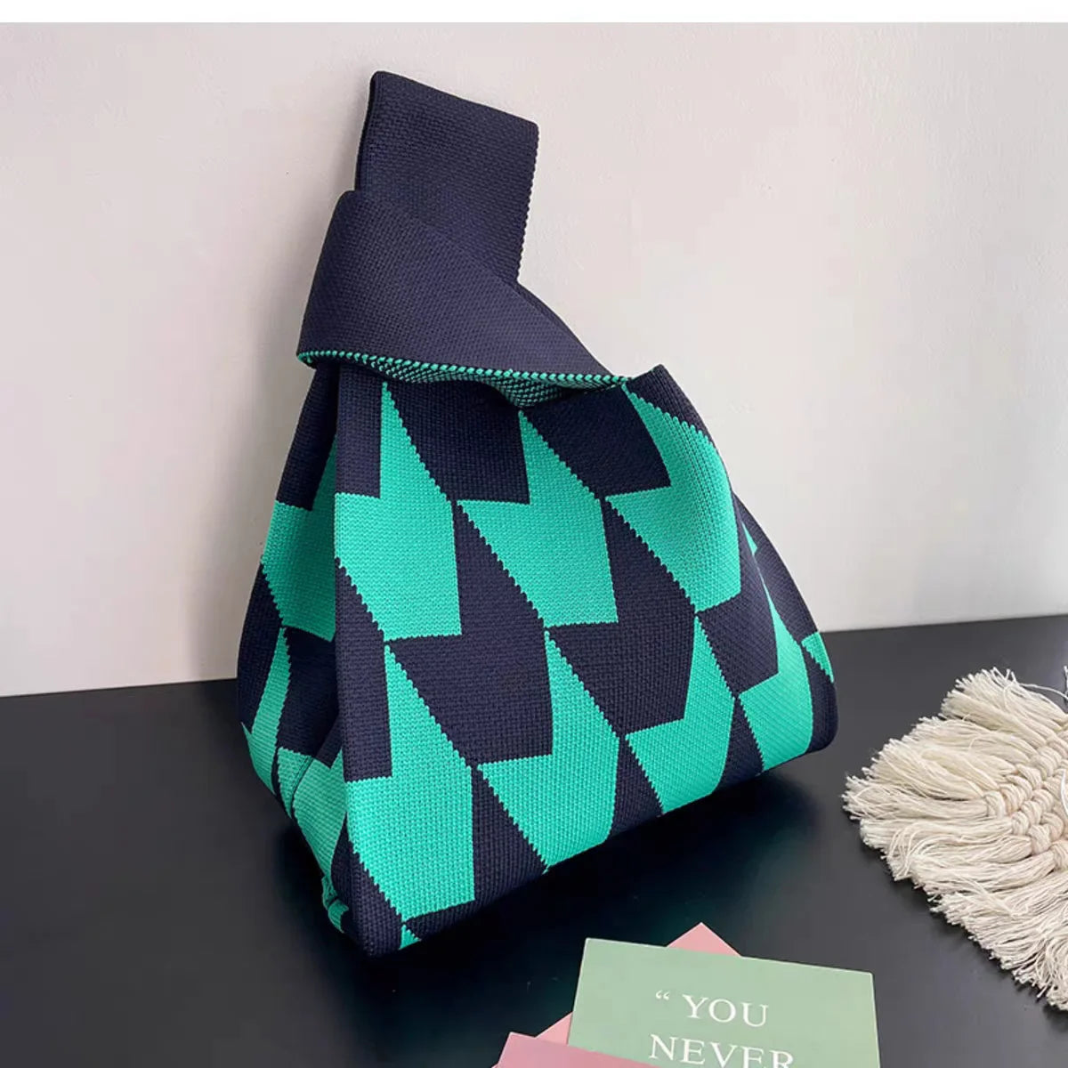 Women's handmade knot wrist bag with a unique knit design, green and black striped pattern, large capacity for autumn and winter use.