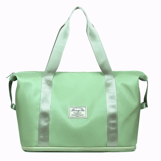 Extendable women's large capacity storage luggage handbag in green, waterproof nylon duffle bag for leisure travel and sports.