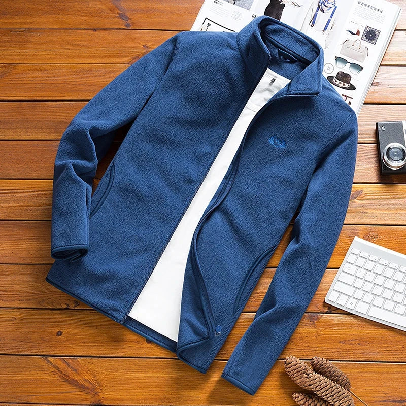 Man Fleece Tactical Softshell Jacket, Windbreaker, Thermal Sporting Outerwear, Blue Army Jacket on Wooden Surface.