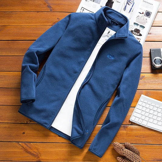 Man Fleece Tactical Softshell Jacket, Windbreaker, Thermal Sporting Outerwear, Blue Army Jacket on Wooden Surface.