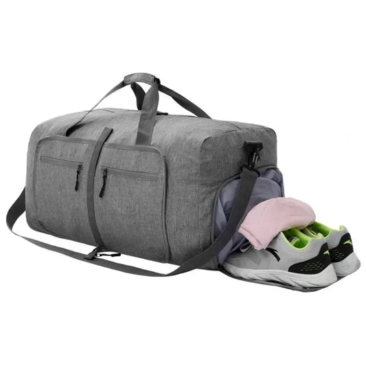 Large capacity 85L travel duffel bag in gray, waterproof Oxford material, foldable design with shoulder strap, featuring multiple pockets including a shoe compartment.