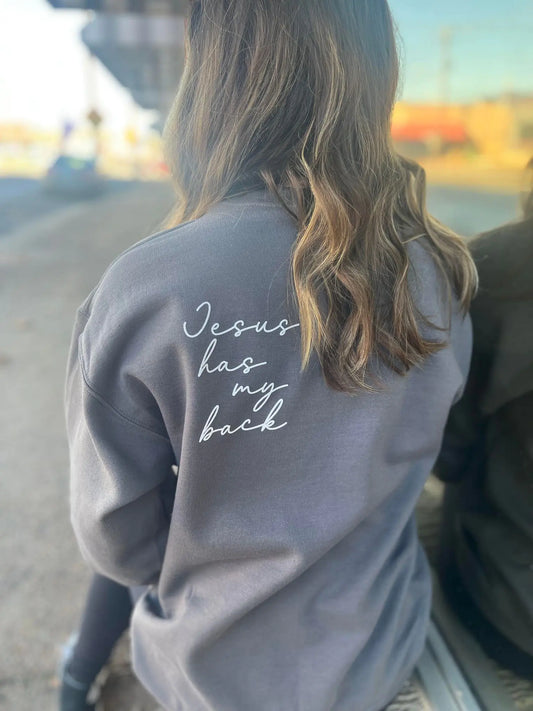 Jesus Has My Back SweatshirtThis ultra comfy sweatshirt is so simple yet so unique! This is a definite need for your closet!Gildan: Charcoal50 Cotton/50 PolyesterProfessionally Screen PrintedUnBack Sweatshirt
