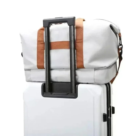 Large capacity travel gym bag on a suitcase with brown straps, waterproof, suitable for men's sports and short-distance luggage needs.