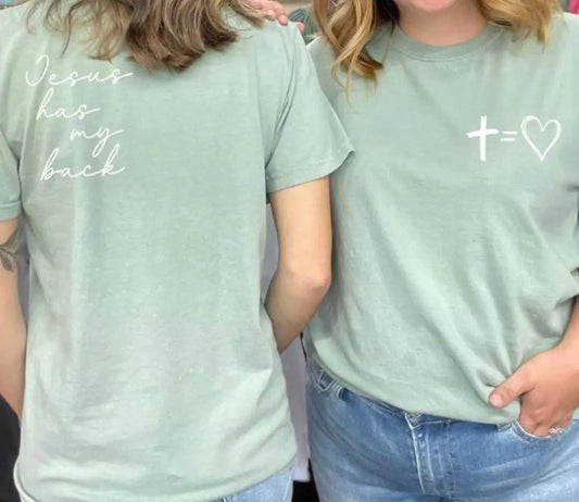 Jesus Has My Back TeeOne of our favorite color tees. Design reads "Jesus has my back" on the back left shoulder with cross equals heart picture on front left chest.Back Tee